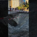 A toddler is learning to walk beside the crater left after Russia’s attack on Ukraine